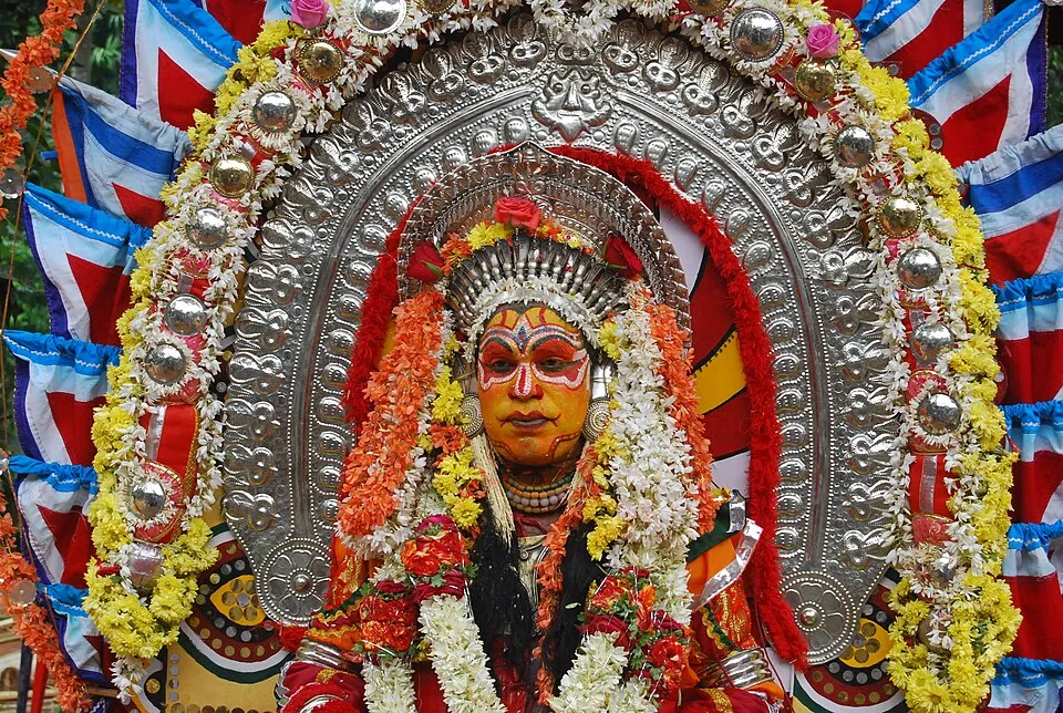 Jumadi in full costume, framed by a silver and flower ani