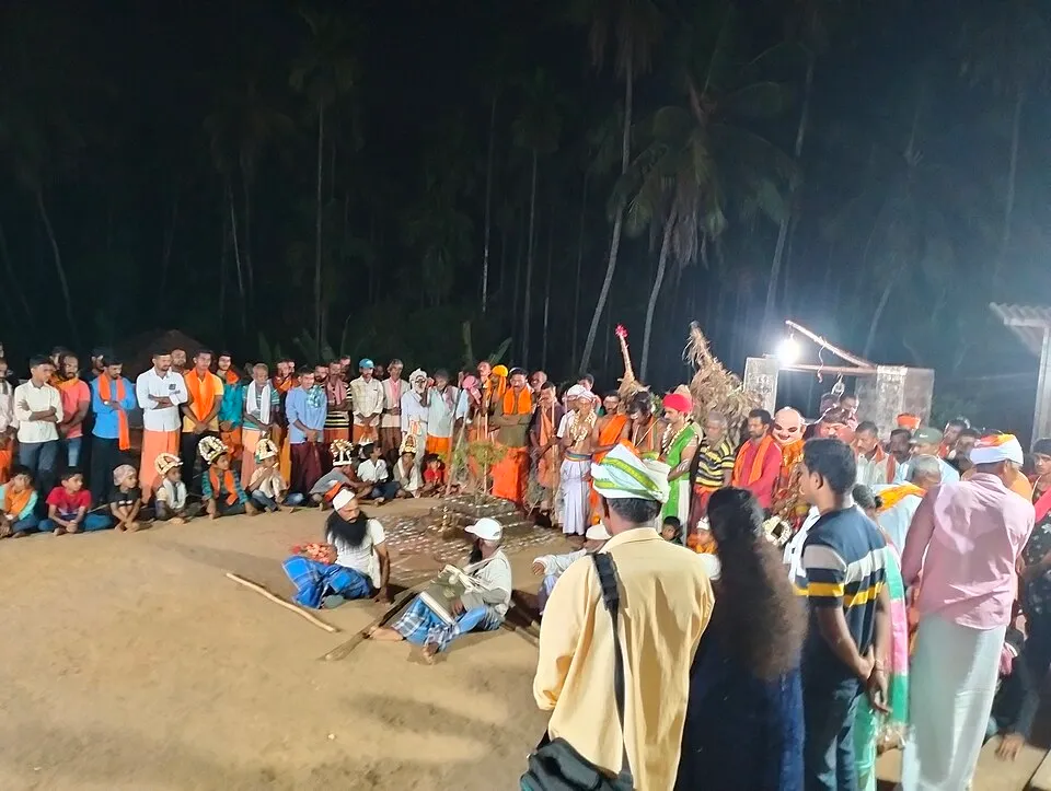 A night performance in a village courtyard, with villagers standing and sitting in a ring around costumed performers